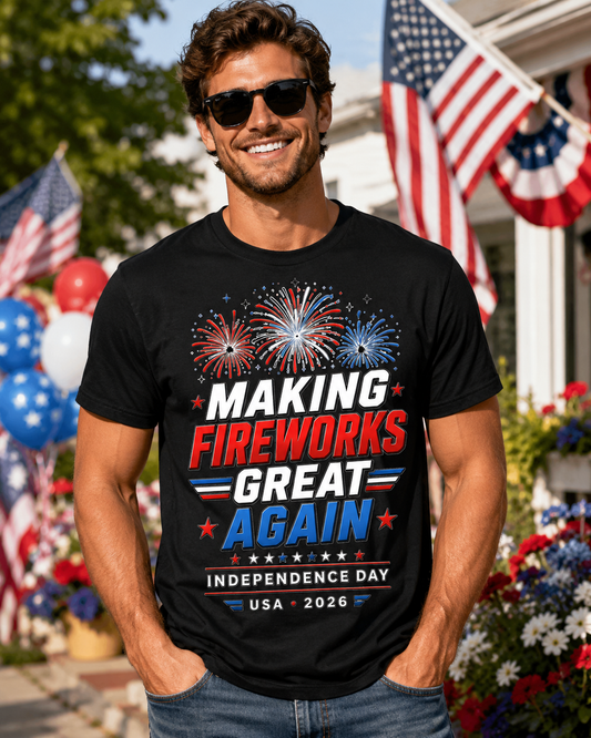 Man wearing a black t-shirt with fireworks design and text, standing in front of American flags and balloons.